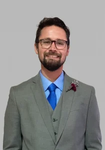 Michael Oberding smiling in a suit.